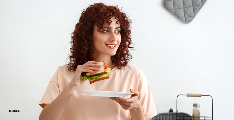 attractive woman with sandwich